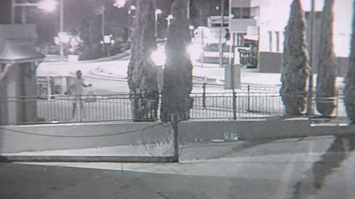 Police are now trying to track down a man they want to speak to who can been seen on CCTV jumping a fence into a carpark, before changing clothes and leaving again.