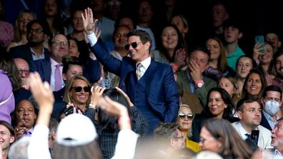 Tom Cruise (centre) waves to the fans as he watches the ladies' singles final between Ashleigh Barty and Karolina Pliskova on centre court on day twelve of Wimbledon at The All England Lawn Tennis and Croquet Club, Wimbledon. Picture date: Saturday July 10, 2021. (Photo by Adam Davy/PA Images via Getty Images)
