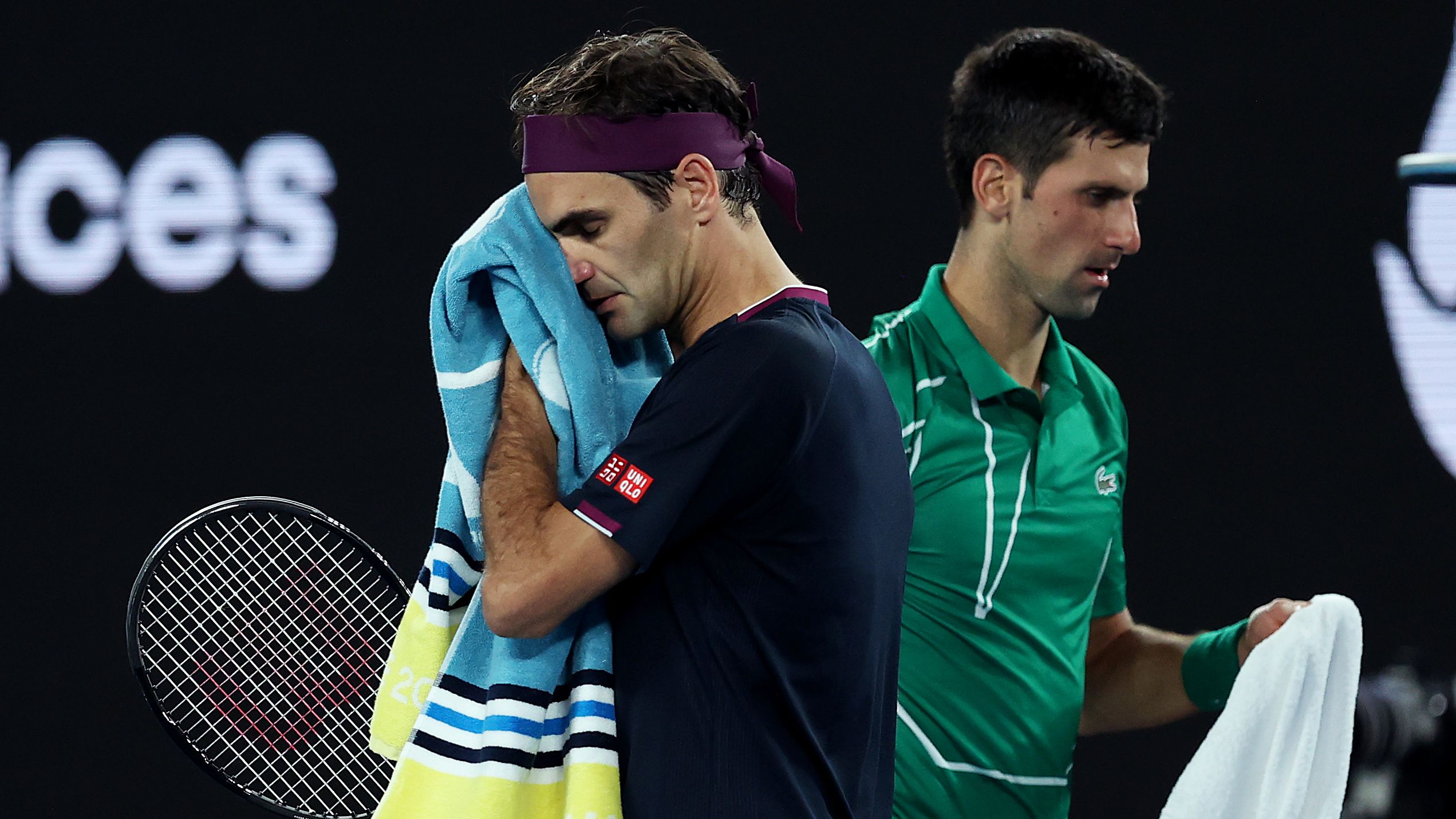 MELBOURNE, AUSTRALIA - JANUARY 30: Novak Djokovic of Serbia walks past Roger Federer of Switzerland during change of ends in their Men&#x27;s Singles Semifinal match on day eleven of the 2020 Australian Open at Melbourne Park on January 30, 2020 in Melbourne, Australia. (Photo by Clive Brunskill/Getty Images)