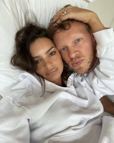 Emily Ratajowski and her husband Sebastian Bear-McClard while lying in bed.