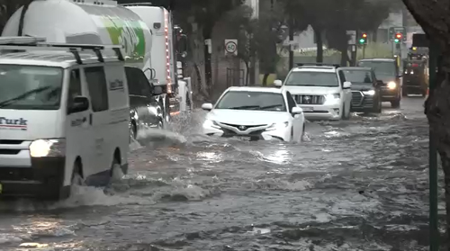 Traffic in Mascot, Sydney was brought to a near standstill as cars slowly waded through flooded streets.