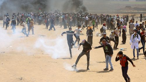 Palestinian protesters burn tires near the Israeli border fence, east of Khan Younis, in the Gaza Strip, Monday, May 14, 2018. Thousands of Palestinians are protesting near Gaza's border with Israel.