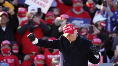 President Donald Trump dances after speaking at a campaign rally at Dubuque Regional Airport, Sunday, Nov. 1, 2020, in Dubuque, Iowa. (AP Photo/Charlie Neibergall)