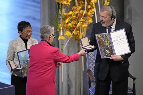 Nobel Peace Prize winners Dmitry Muratov from Russia, right, and Maria Ressa of the Philippines receive their awards from the Norwegian Nobel Committee's leader Berit Reiss-Andersen during the Nobel Peace Prize ceremony at Oslo City Hall, Norway, Friday, Dec. 10, 2021.