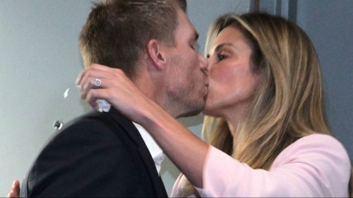 Warner kisses his wife before the press conference began. (9NEWS)