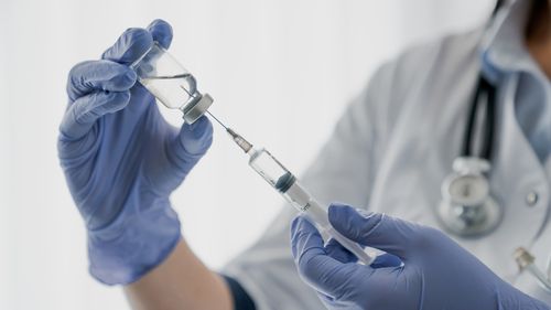 Nurse holding a needle. Injection. Vaccine.