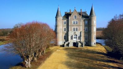 The gorgeous chateau is surrounded by a moat, adding to its grandeur.