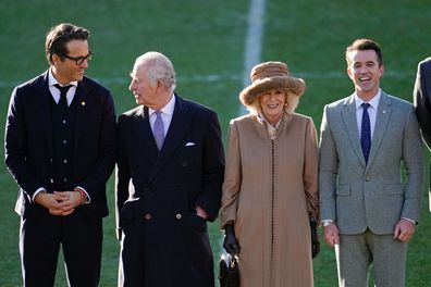 King Charles III and Camilla, Queen Consort talk to Co-Owners Wrexham AFC Ryan Reynolds (L) and Rob McElhenney (R) during their visit to Wrexham AFC on December 09, 2022 in Wrexham, Wales.  