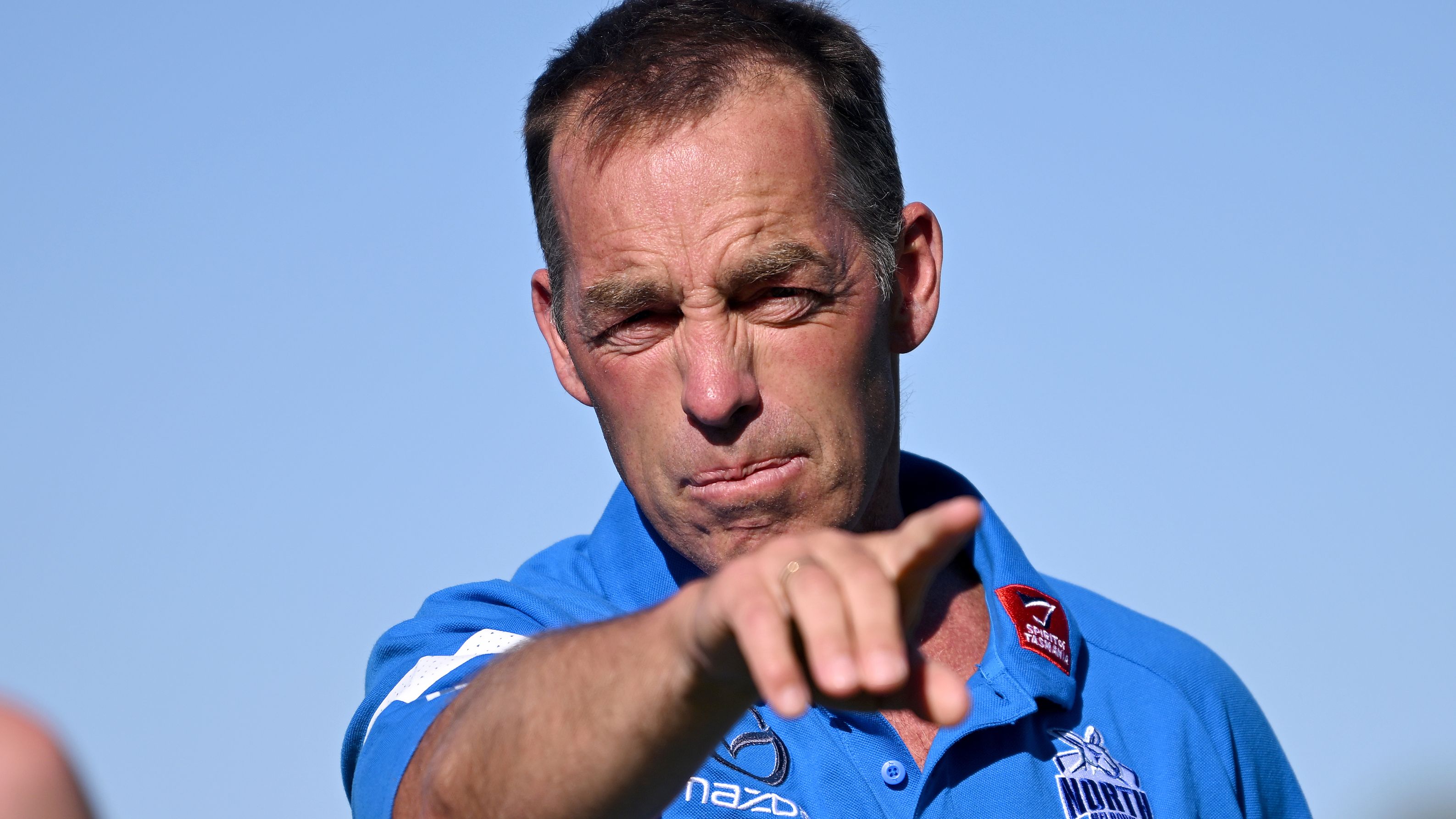 ROCHESTER, AUSTRALIA - FEBRUARY 13: Alastair Clarkson, senior coach of the Kangaroos talks Rochester footballers through a training drill during the North Melbourne Kangaroos AFL Community Camp at the Rochester Recreation Reserve on on February 13, 2023 in Rochester, Australia. (Photo by Morgan Hancock/Getty Images)