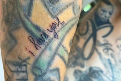 Kourtney Kardashian inked "I love you" on Travis Barker's forearm.