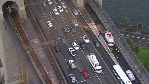 Four protesters have been charged after an entire citybound lane was shut down on the Sydney Harbour Bridge during the peak rush hour this morning.