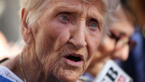 92-year-old Eileen Piper, whose daughter Stephanie killed herself after allegedly being raped by a priest, looks downwards before speaking to the media after attending the Royal Commission.