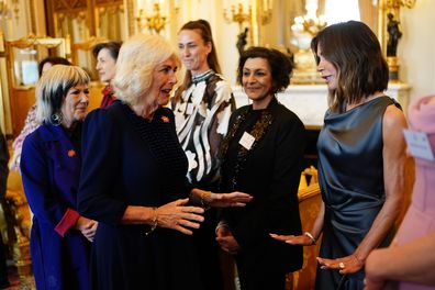 Queen Camilla greets Victoria Beckham