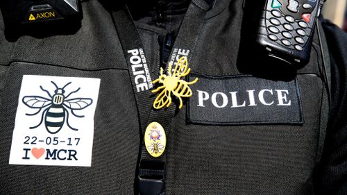 A police officer wears a bee, which has become a symbol of unity since the attack. (AAP)