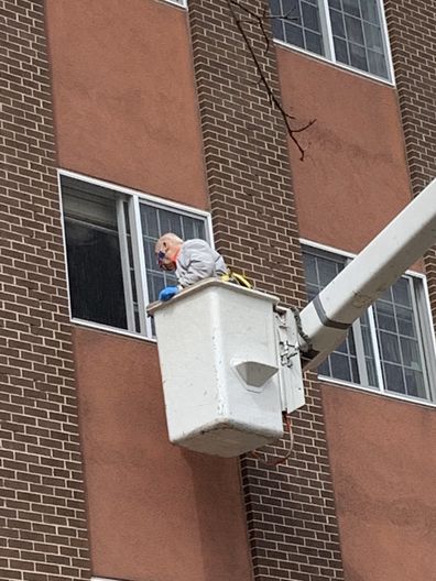 Nick was launched into the air to see his wife on a cherry picker with the help of his son Chris.