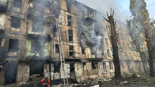 Emergency workers extinguish a fire after missiles hit a multi-story apartment building in Kryvyi Rih, Ukraine, Tuesday, June 13, 2023.