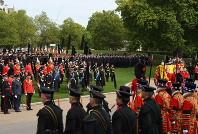 Members of the Royal Family including Prince William, Prince of Wales, Prince Harry, Duke of Sussex, King Charles III, Camilla, Queen Consort, Anne, Princess Royal, Prince Andrew, Duke of York, and Prince Edward, Earl of Wessex at Wellington Arch watching the coffin of Queen Elizabeth II being taken onto the State Hearse on September 19, 2022 in London, England. 