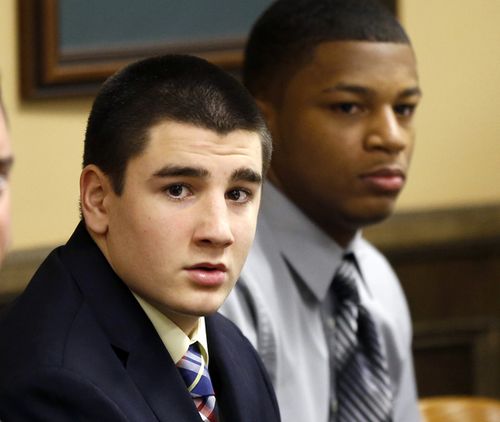 High school quarterback Trent Mays, 17, and 16-year-old wide receiver Ma'lik Richmond sit at the defence table before the start of their trial on rape charges in juvenile court, Ohio. 