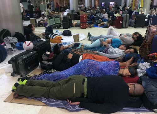 It is believed it could take up to four days for tourists, who are currently choking up Lombok Airport, to be able to fly out. Picture: AAP.