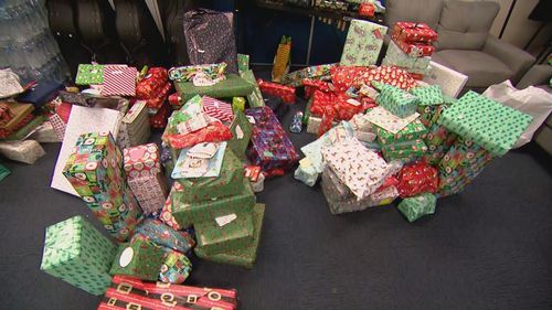 Locals and businesses donating hundreds of presents under the tree for flood-affected children, including soccer balls, skateboards, drones and gift vouchers among the haul.