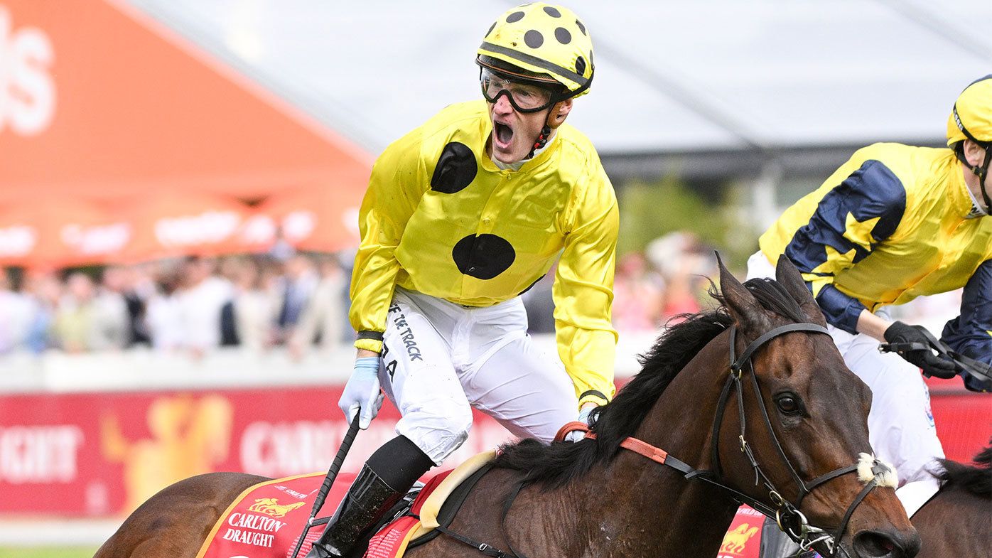 Mark Zahra celebrates after taking out the 2023 Caulfield Cup atop of Without A Fight