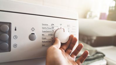 Man preparing the washing machine to start working