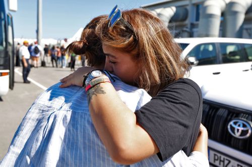 Australian national hugs a journalist Jess Millward upon her arrival at Larnaca International Airport, after being evacuated from Beirut on October 5, 2024 in Larnaca, Cyprus.