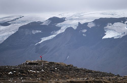 A man stops on his way to the top of what once was the Okjokull glacier, in Iceland
