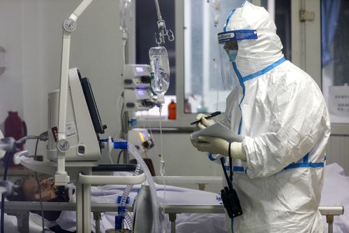 A medical worker records a patient's condition at Jinyintan Hospital designated for new coronavirus infected patients, in Wuhan in central China's Hubei province.