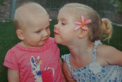 Big sister Elle kisses Elaina whom she adored.