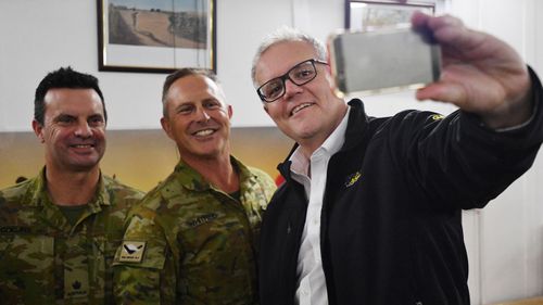 Australian Prime Minister Scott Morrison takes a selfie with Australian troops during a visit to Task Group Taji at Taji Military Complex in Iraq.