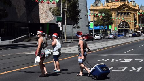 Silly season beachgoers in Melbourne's CBD (Image: AAP)