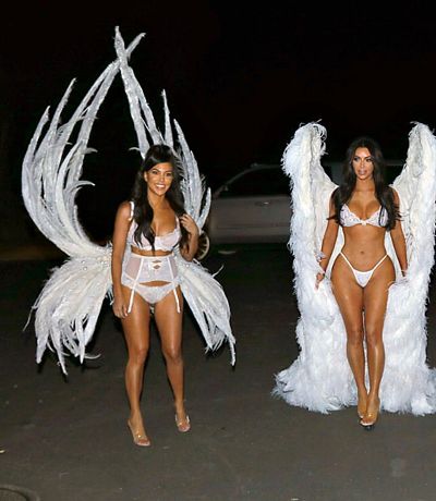 Kourtney and Kim Kardashian strutting their stuff in their barely-there feathered outfits.