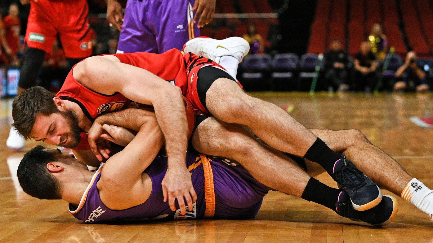 Nick Kay of the Wildcats and Kevin Lisch of the Kings fall on the court during Game 3 of the NBL Finals match at Qudos Bank Arena