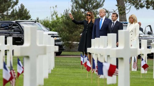 The Trumps and the Macrons visit a cemetery in Normandy.