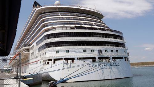 The Carnival cruise line ship Carnival Magic sits docked on April, 2020, in Cape Canaveral, Fla. The US Coast Guard said  that it's searching for a man who fell from the cruise ship off the coast of Florida. 