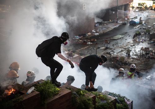 The anti-government protesters barricaded themselves inside Polytechnic last week. Police surrounded the area on Sunday night and began moving in after issuing an ultimatum for people to leave the area. The crowd wore raincoats and carried umbrellas to shield themselves from police water cannons. 