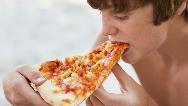 Boy eating pizza