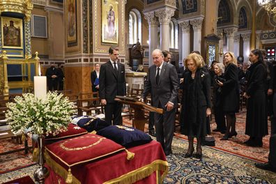 In this handout photo former Spanish King Juan Carlos, center, and Spain's former Queen Sofia attend the funeral of former king of Greece Constantine II at the Metropolitan cathedral in Athens, Monday, Jan. 16, 2023. A crowd of thousands chanted "long live the king" and "Constantine, Constantine" on Monday.  