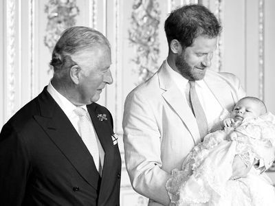 Prince Charles with Prince Harry and young Archie on his christening..