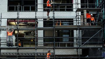 Workers are seen taking down cladding ahead of the first view of the North Sydney Metro station, in North Sydney, Friday, 31 May 2024.