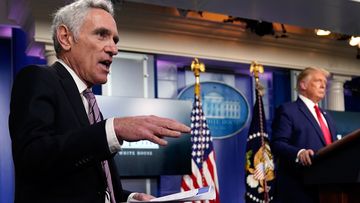 White House coronavirus adviser Dr. Scott Atlas speaks as President Donald Trump and White House press secretary Kayleigh McEnany listen during a news conference at the White House