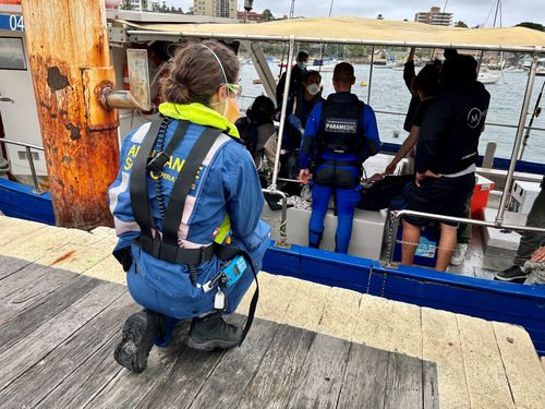 A doctor assessed the patient on the wharf before she was transferred to hospital.