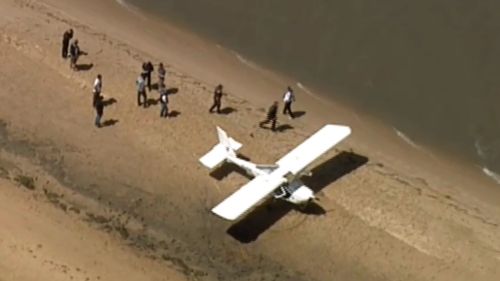 Plane stuck in sand after landing at remote beach in Victoria