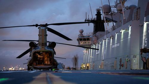 HMAS Adelaide embarks Australian Army CH-47 Chinook Heavy-Lift Helicopters before departing the port of Brisbane, to provide humanitarian assistance to the Government of Tonga.