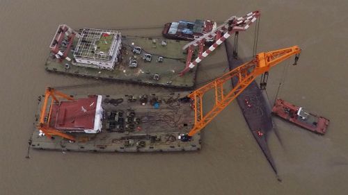 Battle to right capsized China ship as death toll hits 77