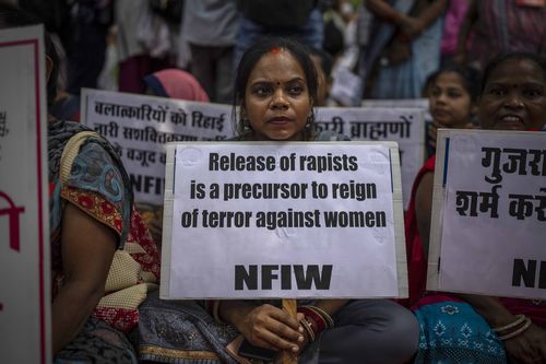 A protestor holds a placard against remission of sentence by the government to convicts of a gang rape of a Muslim woman, in New Delhi, India, Saturday, August 27, 2022.  