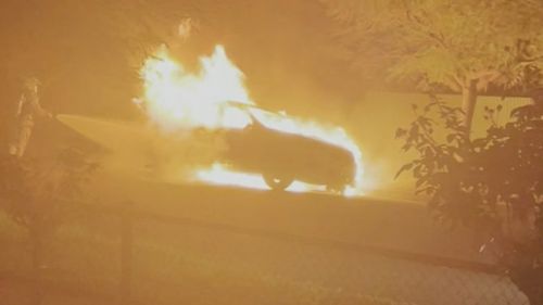 Two people were seen running away from a burning BMW station wagon in Adelaide early this morning.