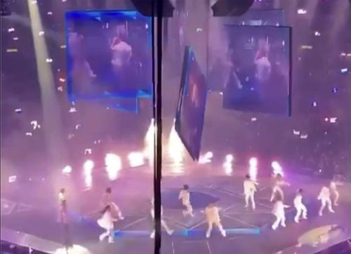 In this image made from video taken from social media, a video screen suspended above the stage falls onto the stage where dancers perform at a concert of Cantopop boy band Mirror in Hong Kong, Thursday, July 28, 2022. 