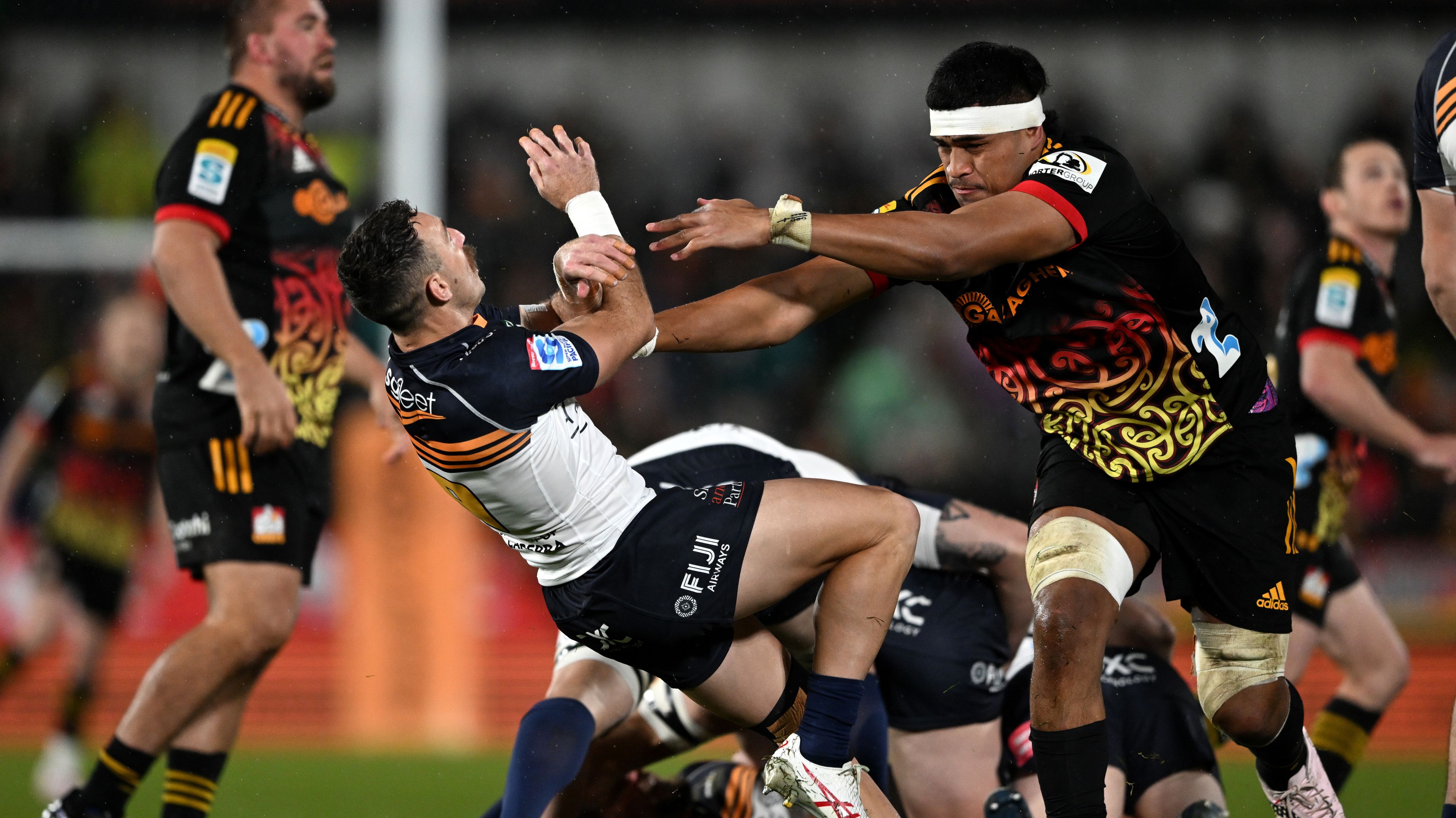 Tupou Vaa&#x27;i of the Chiefs pushes Nic White of the Brumbies.